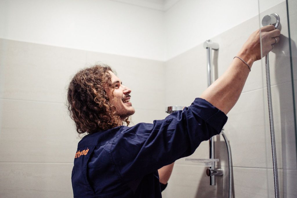 Plumber fixing a shower in North Beach