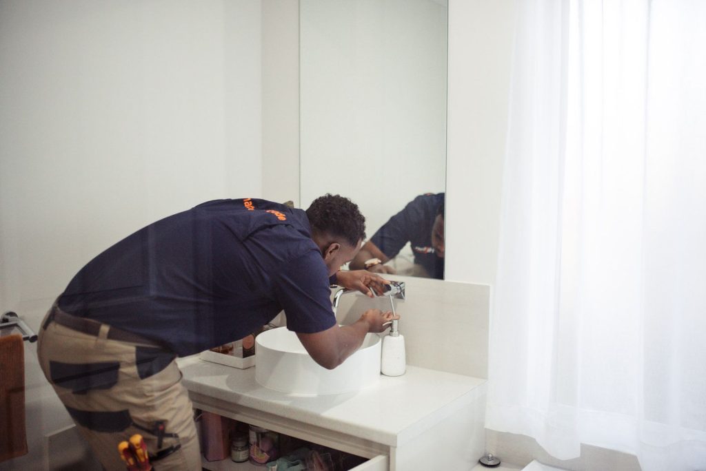 Plumber fixing a sink in Peron